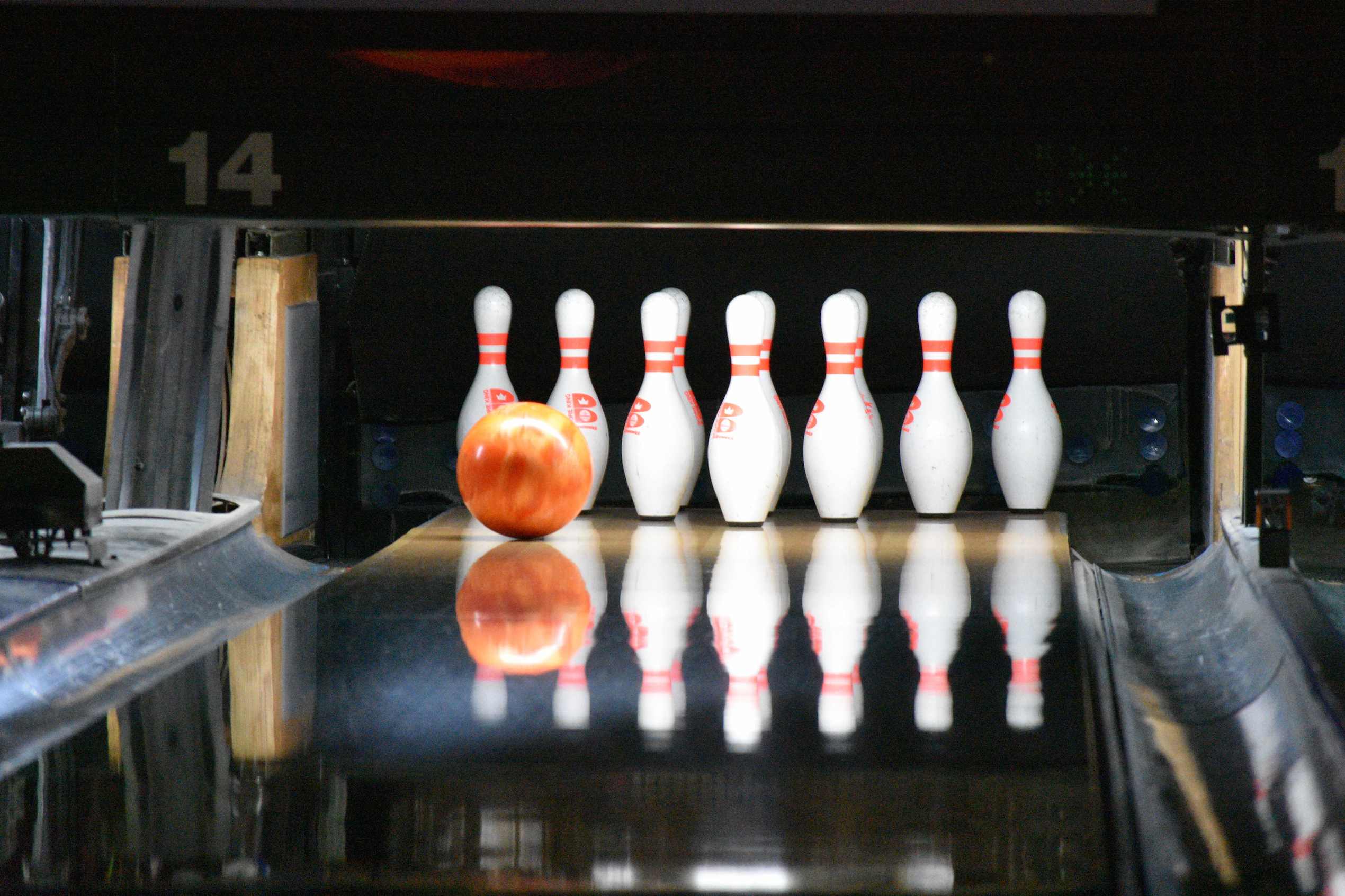 A bowling ball in line for a strike.