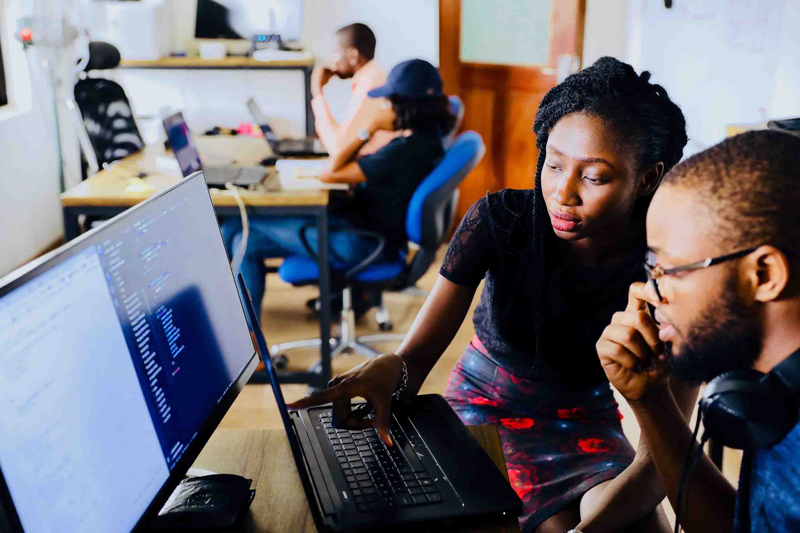 Two people working on a computer.