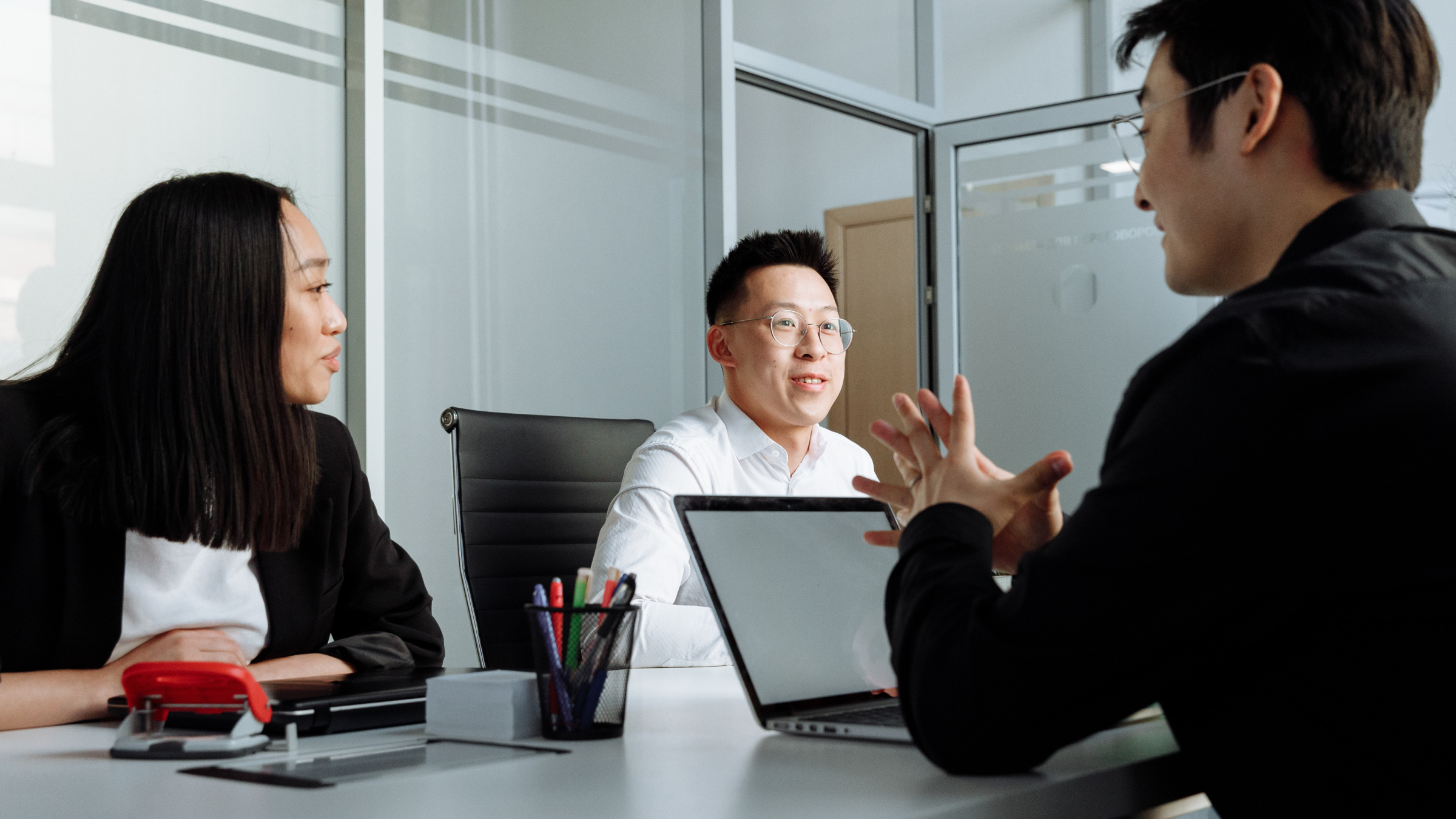 Three employees in a meeting.